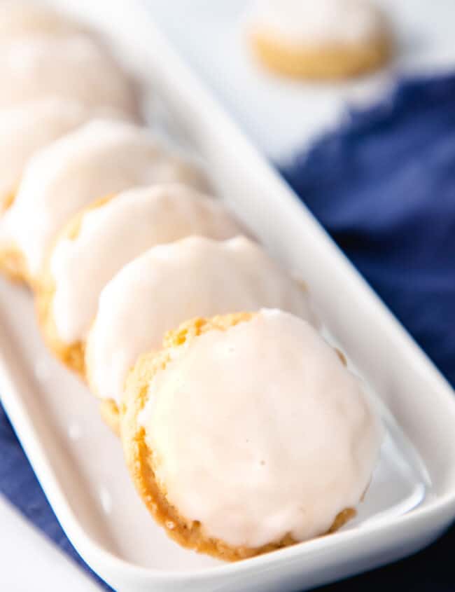 a row of iced soft sugar cookies on a plate
