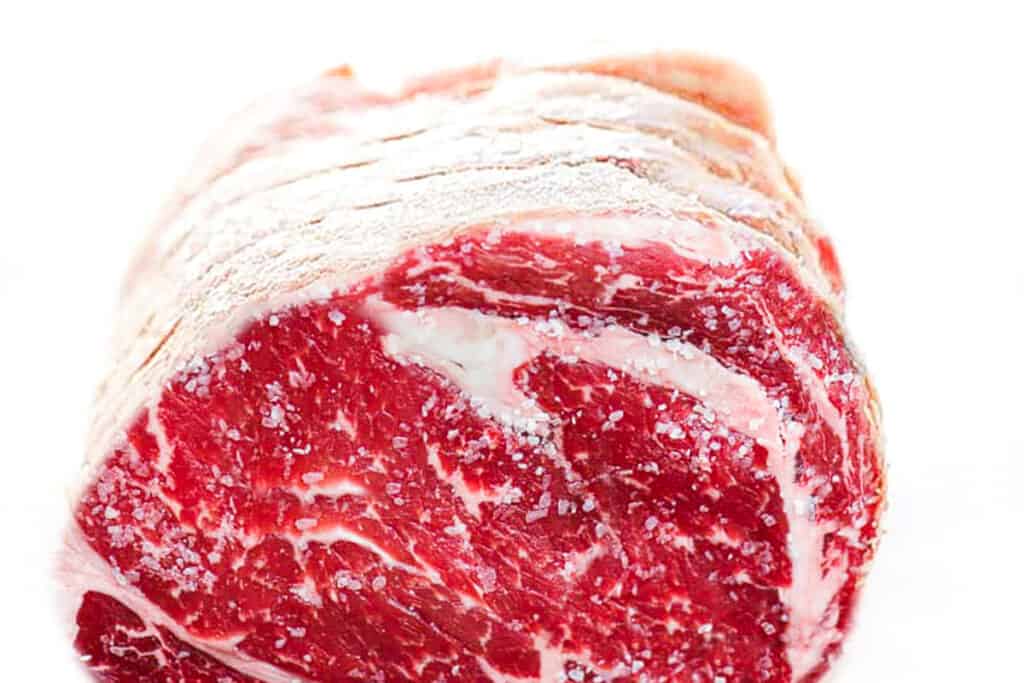 a boneless prime rib roast coated in salt