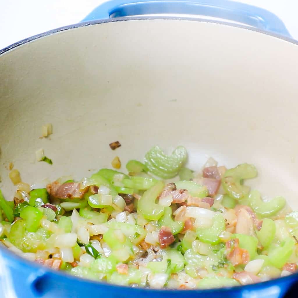 sauted onions and celery in a stockpot with bacon