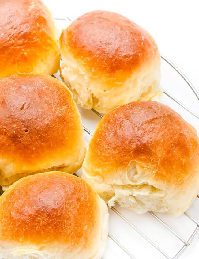 homemade dinner rolls on a cooling rack