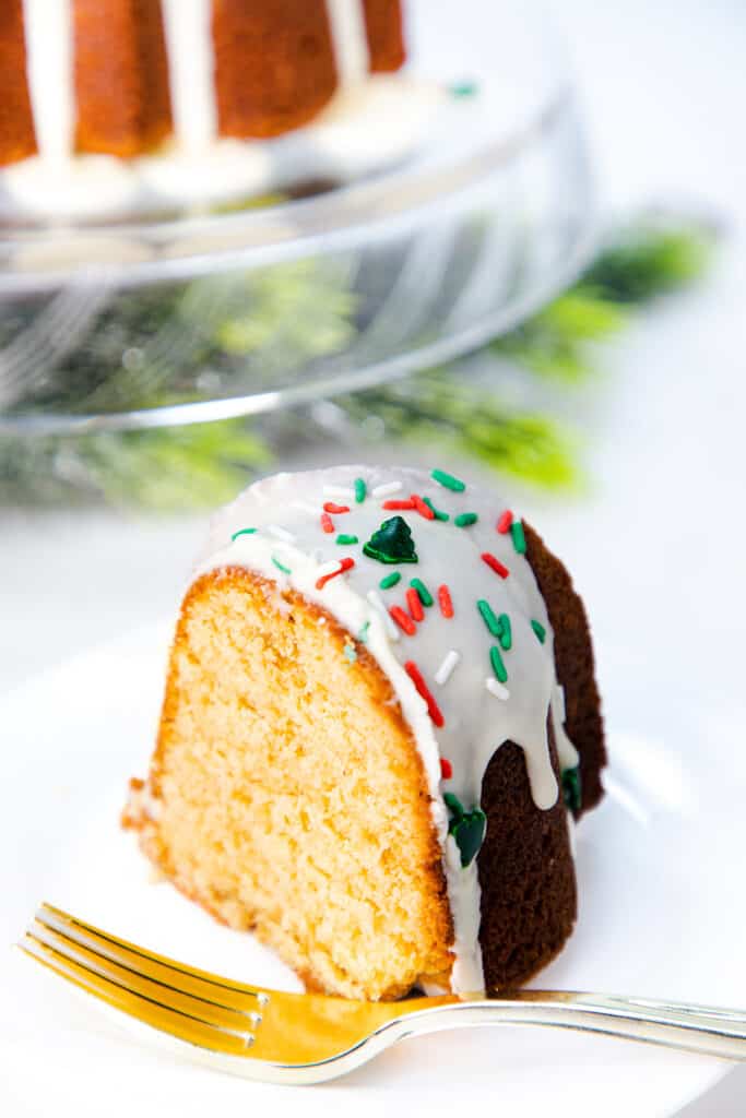 a slice of Eggnog Cake on a plate with a fork
