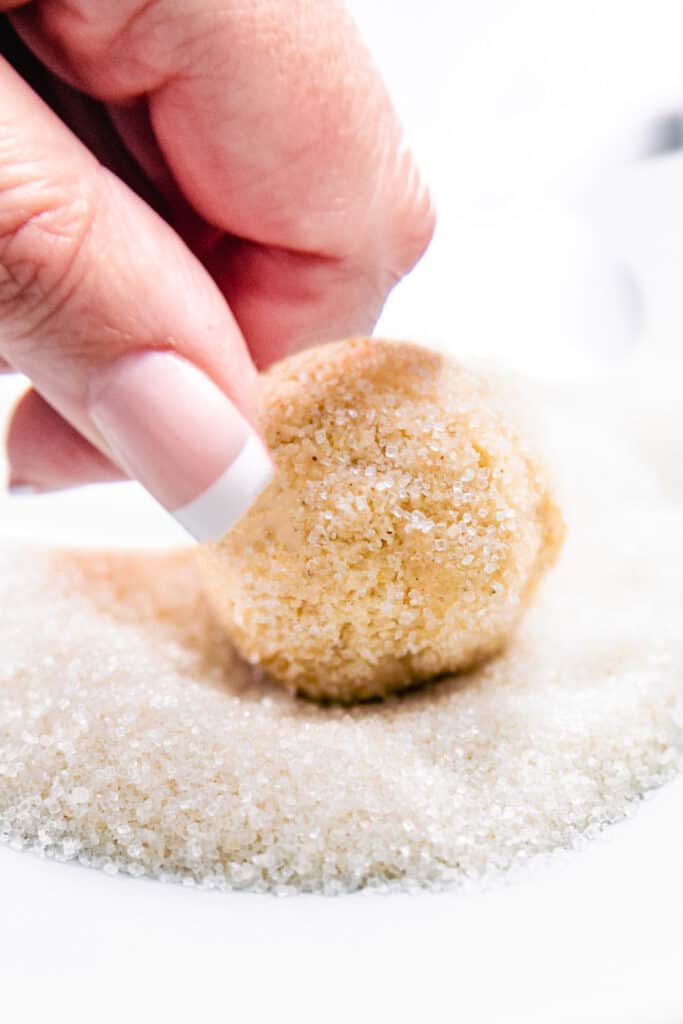 a ball of dough being rolled in sugar
