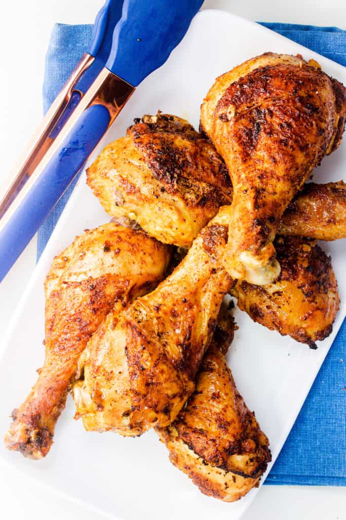 an overhead image of a platter of baked chicken legs.