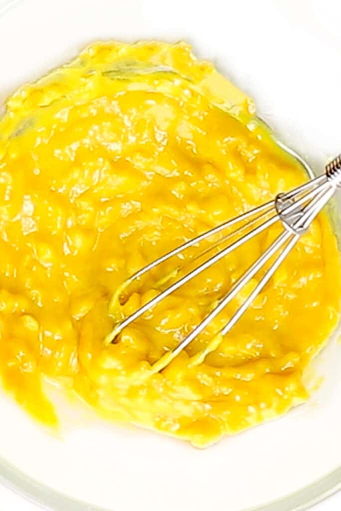 Mustard, garlic, and oil mixed together in a bowl
