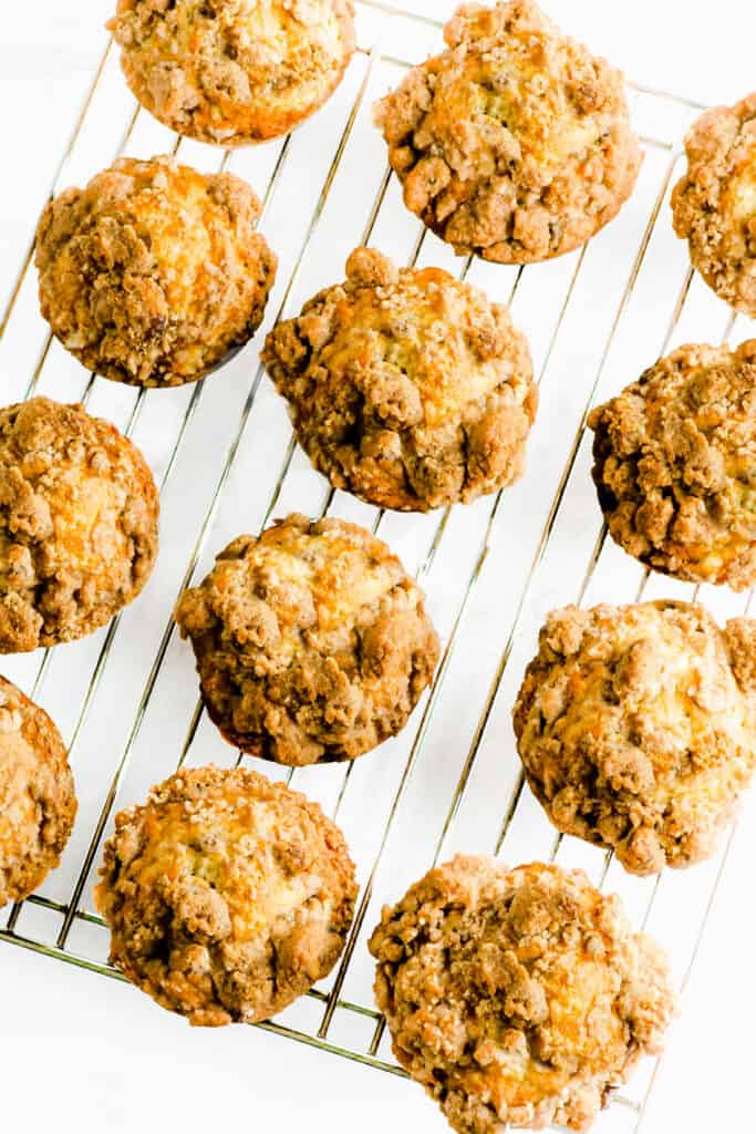 a cooling rack full of Cinnamon Banana Crumb Muffins