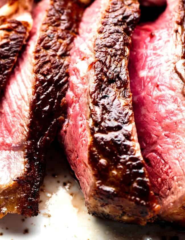 a close up image of a sliced steak cooked to medium rare