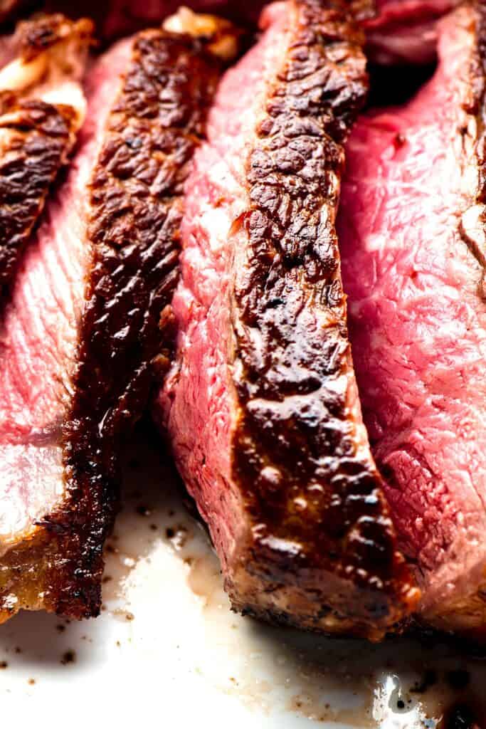 a close up image of a sliced steak cooked to medium rare