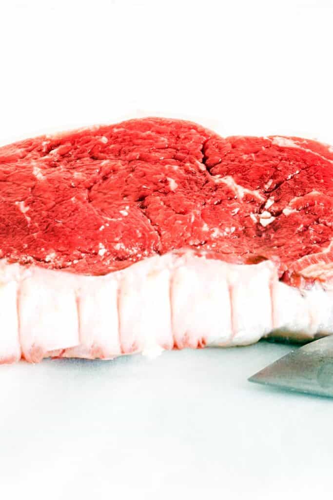 Raw meat on a white board with the fat cut