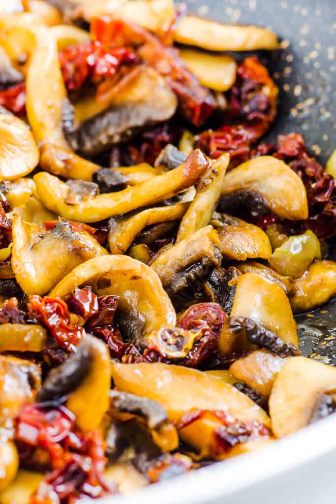 the mushrooms, garlic, and sundried tomatoes in a pan