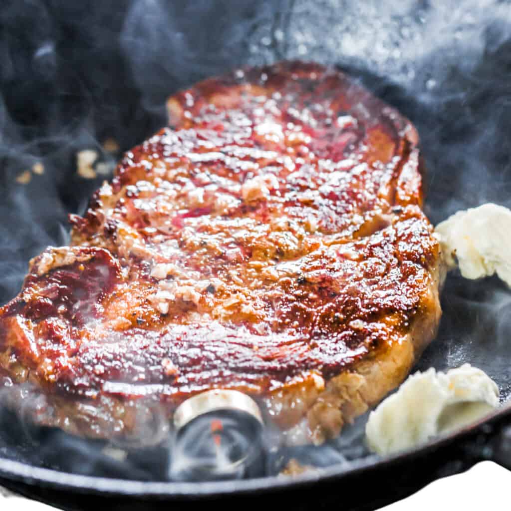 the butter added to the pan with the steak