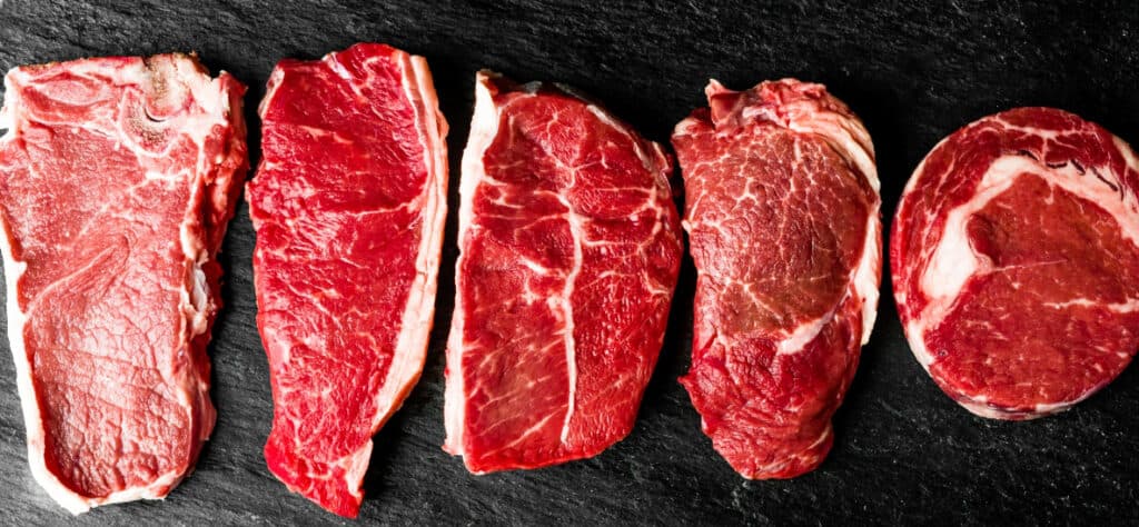 different cuts of steak on a cutting board