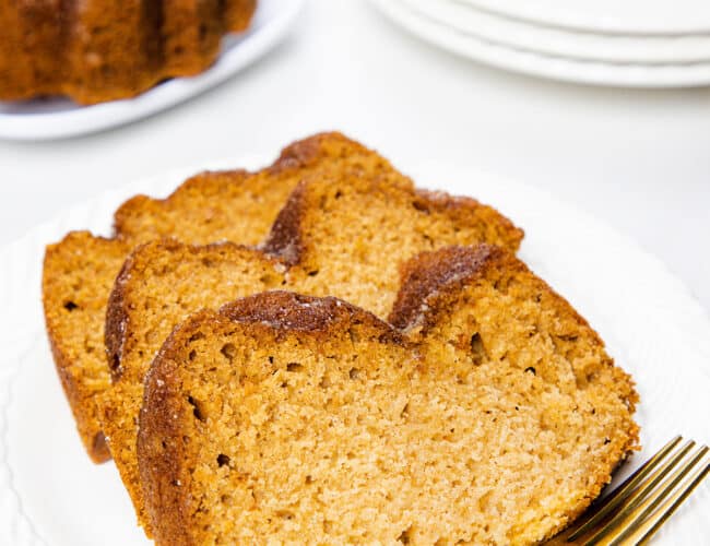 Three slices of Applesauce bread on a white plate with a fork
