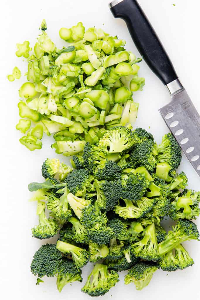 broccoli stems and florets cut and separated on a cutting board