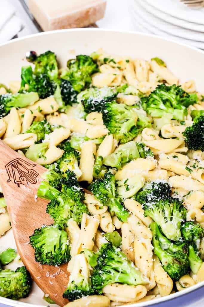 a close up image of a pan of Cavatelli and Broccoli with a serving spoon