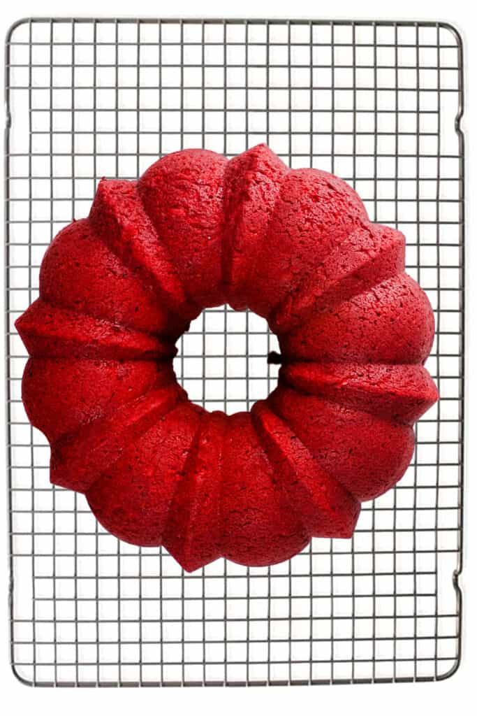 A Red Velvet Bundt Cake cooling on a cooling rack