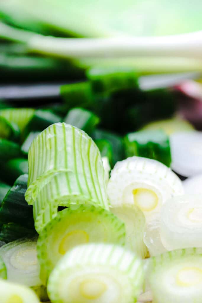 sliced green onions on a chopping board