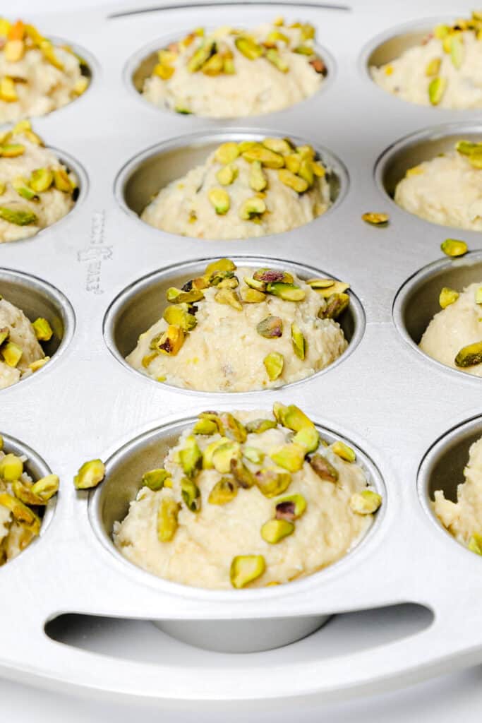 Chopped pistachios on top of the batter in the pan