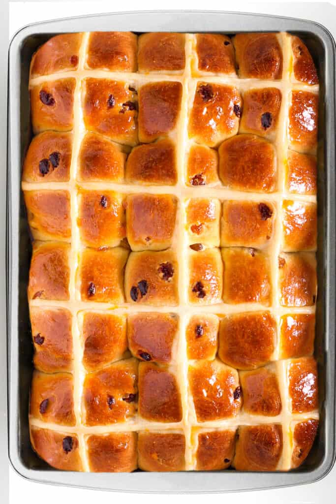 the baked, glazed Hot Cross Buns in the pan
