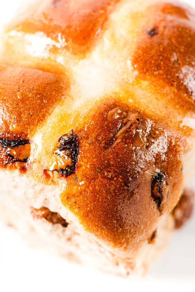 a close up image of the corner of a hot cross bun