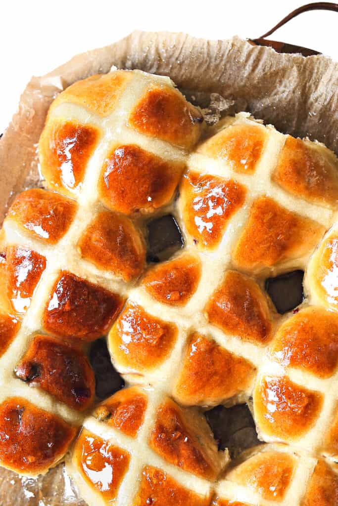 An overhead image of plater of glazed Hot Cross Buns