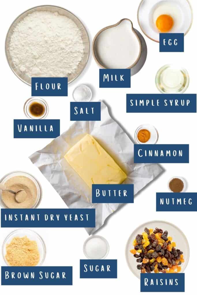all of the ingredients for hot cross buns laid out on a table