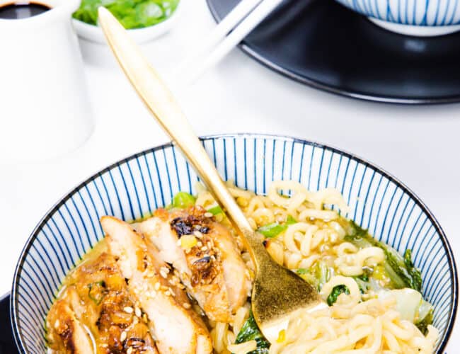 a bowl of Miso Ramen soup with a fork twirling the noodles