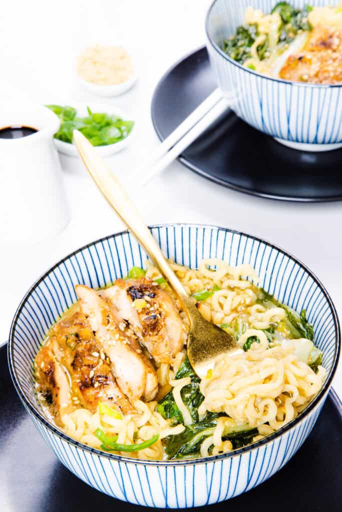 a bowl of Miso Ramen soup with a fork twirling the noodles