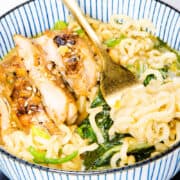 a close up image of a bowl of Miso Ramen soup with a fork twirling the noodles