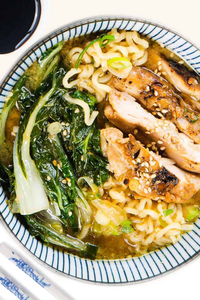 a close up image of Miso Ramen topped with sliced chicken