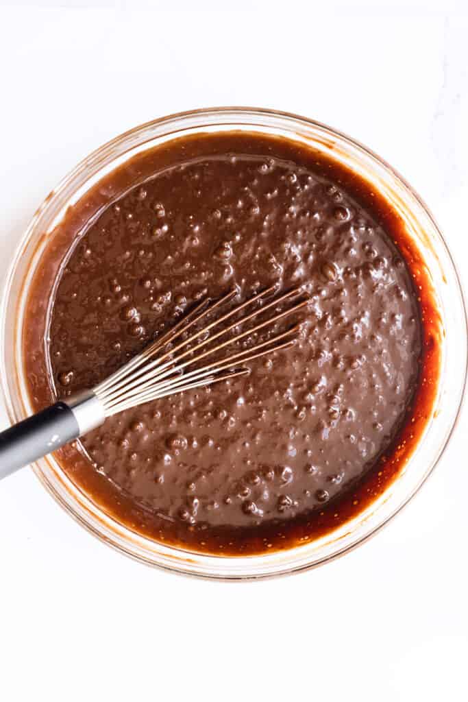 the cake batter mixed in a glass bowl