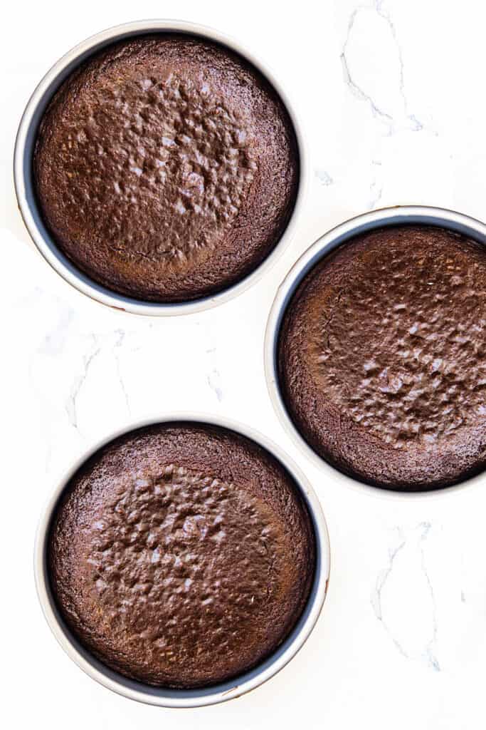 the baked cakes in their pans fresh from the oven