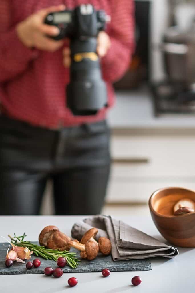 a food photographer looking a camera