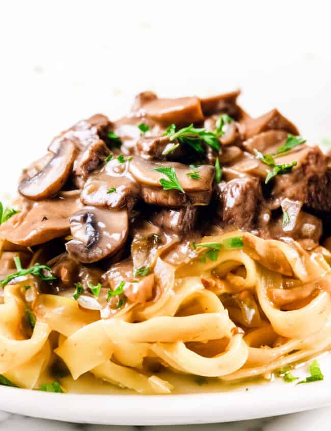 Beef Stroganoff made up of Beef and mushrooms in a creamy Stroganoff sauce over noodles
