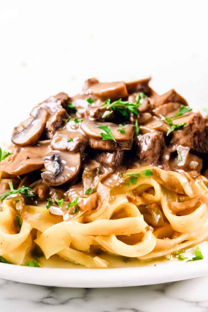 Beef Stroganoff made up of Beef and mushrooms in a creamy Stroganoff sauce over noodles