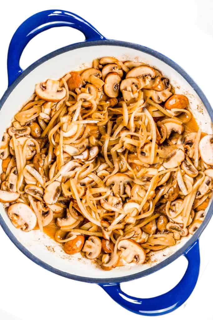 the cooked mushrooms and onions in the pan.