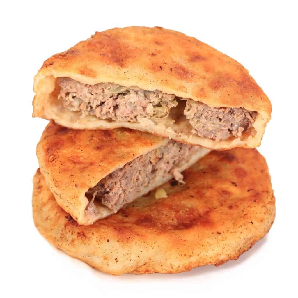 two stocked Xie Bing with one cut in half to show the meat filling