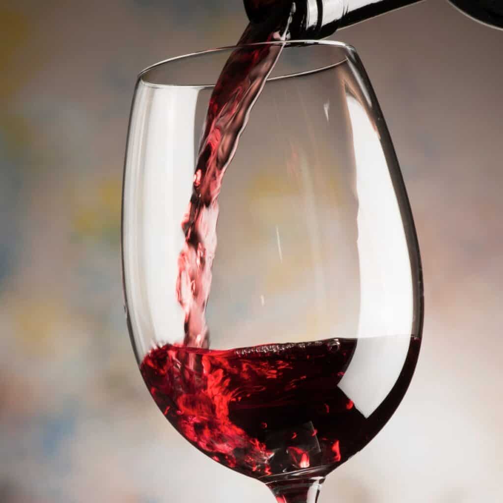 Xinomavro Wine being poured into a wine glass.