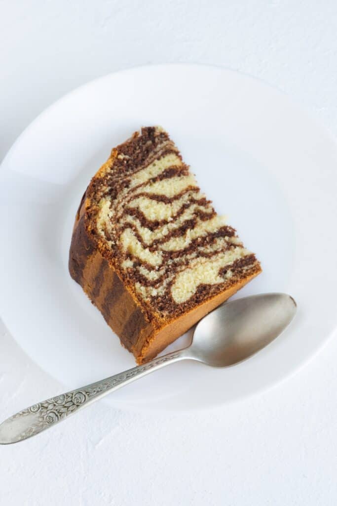 a slice of striped zebra cake on a plate