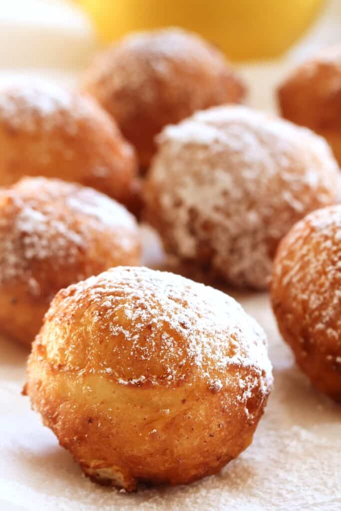 a platter of Zeppole dusted with powdered sugar.