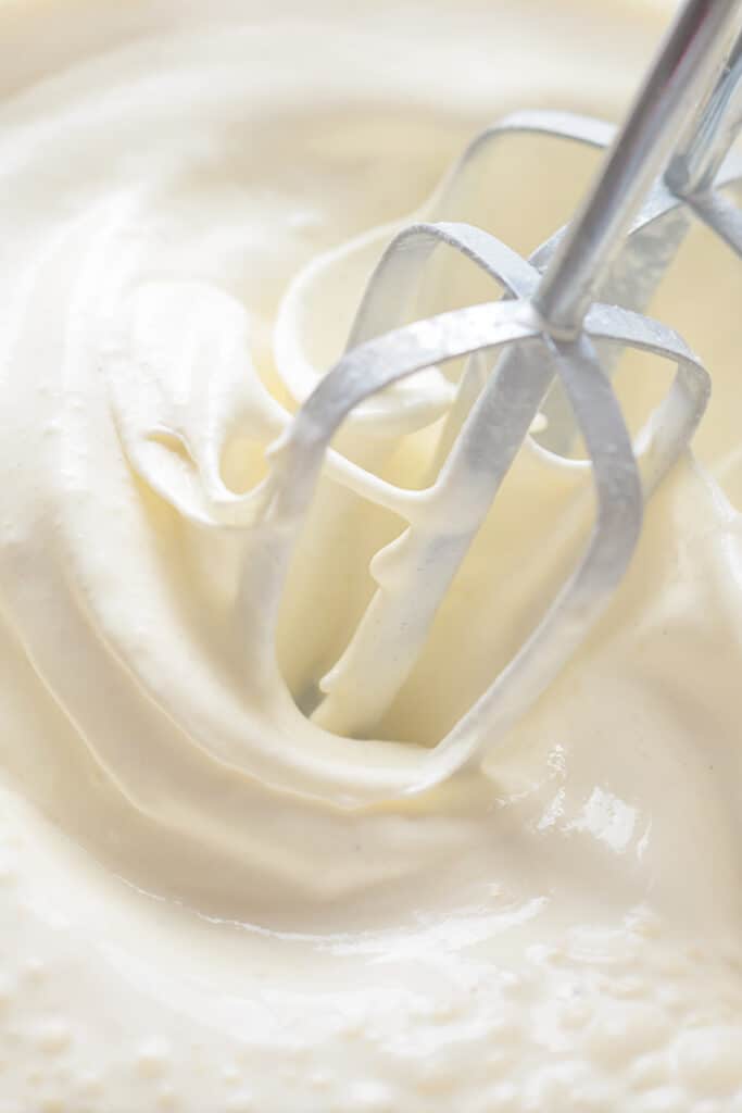 beaters mixing ingredients in a bowl