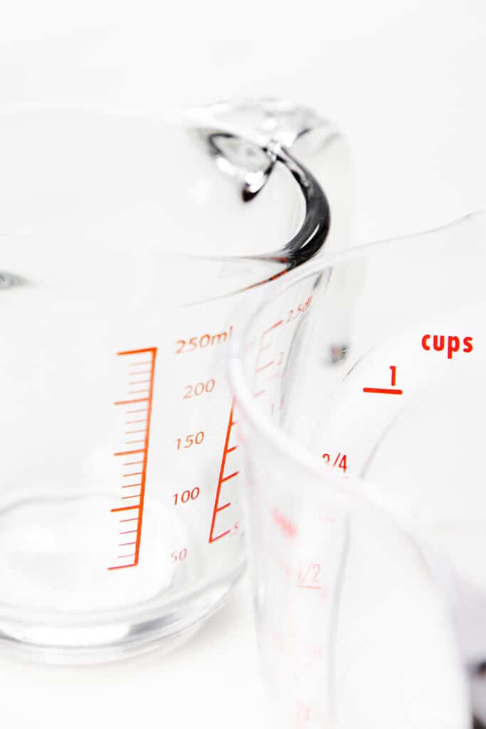 two measuring cups in oz and ml