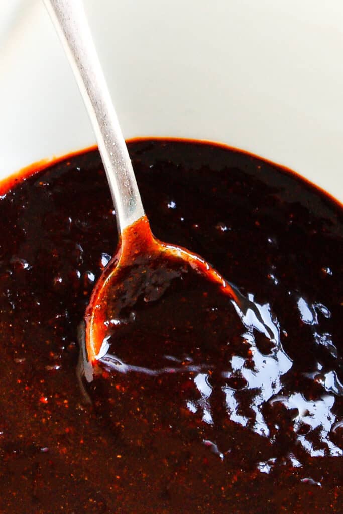 a bowl of Carolina BBQ sauce with a spoon in it