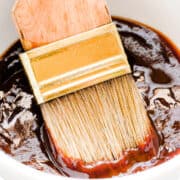 a bowl of Carolina BBQ sauce with a brush