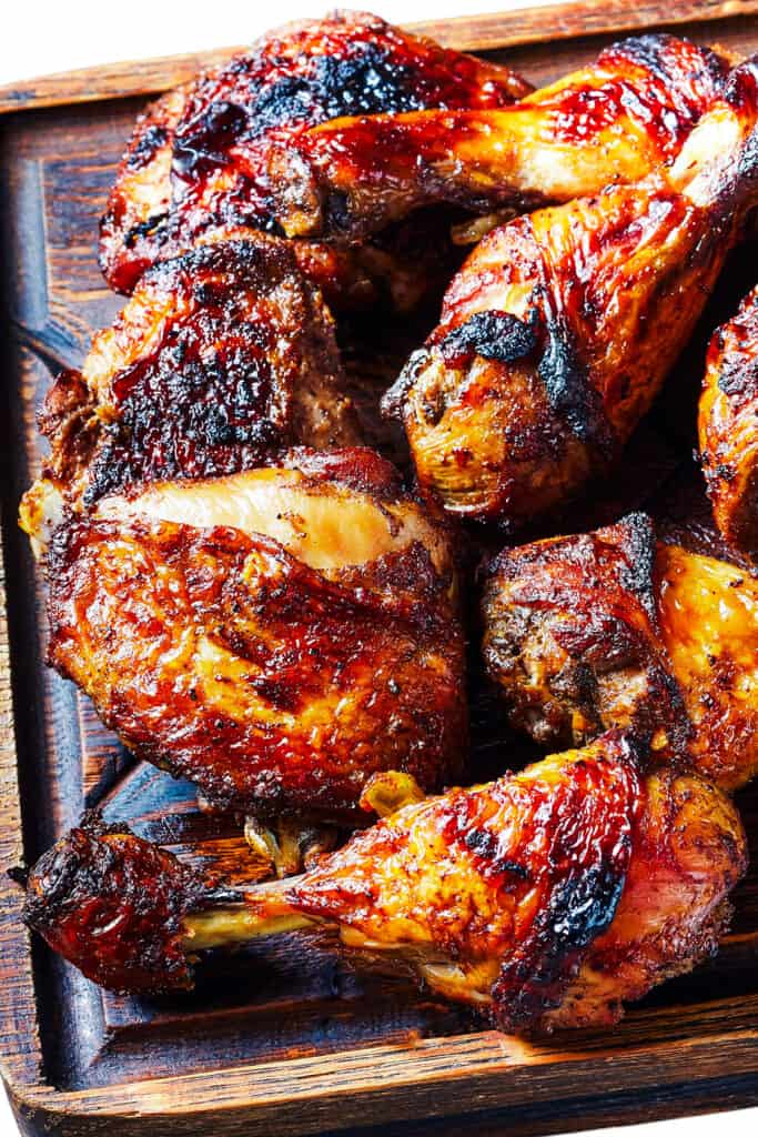 a wooden platter piled with Grilled Chicken Thighs & Legs