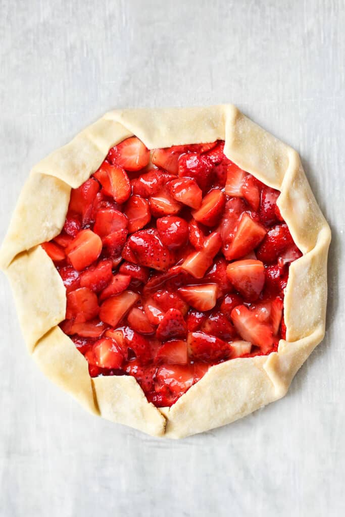 the dough folded over the Strawberry Galette filling on the pan
