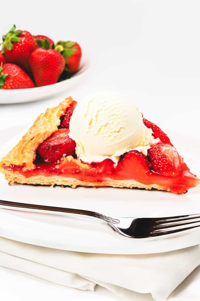 a slice of Strawberry Galette topped with vanilla ice cream