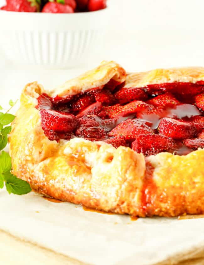 a close up image of a Strawberry Galette shot from the side to show the golden puff pastry crust.