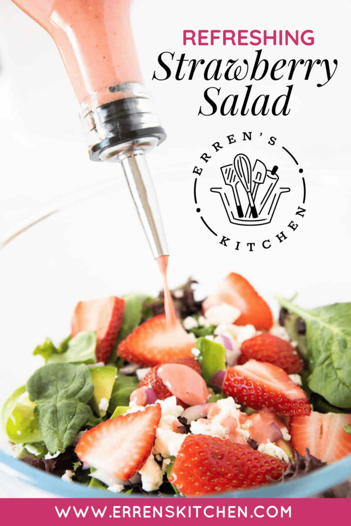 A refreshing strawberry salad with strawberry vinaigrette being drizzled on top.