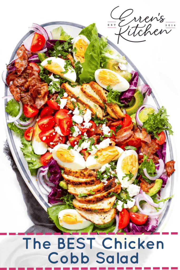 A large platter of cobb salad with chicken, bacon, avocado, tomatoes, and hard boiled eggs.