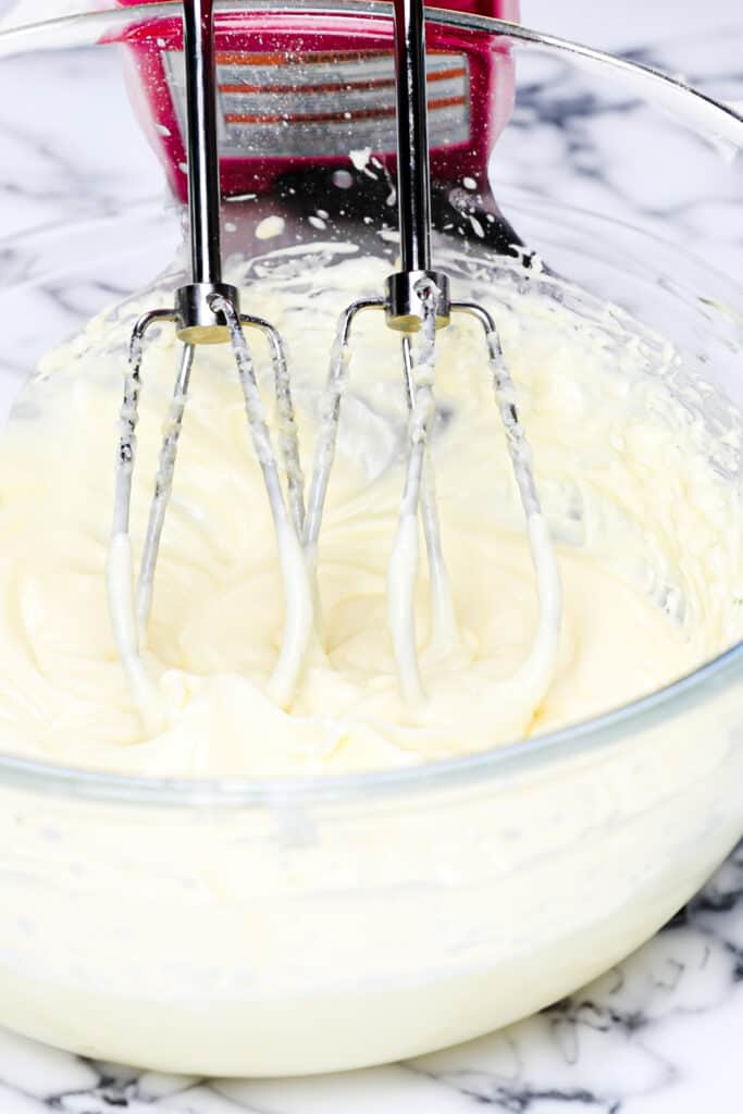 cream cheese and butter whipped together in a bowl with a hand mixer.